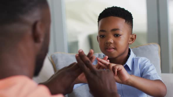African american father teching his son sign language