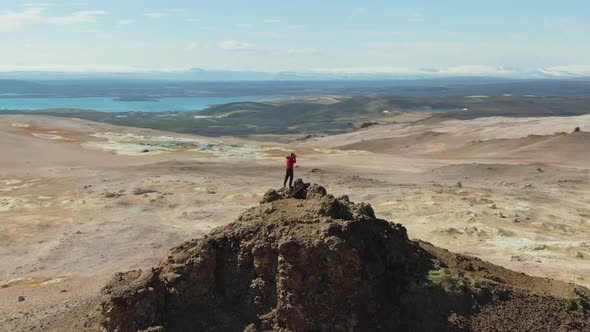 Photographer Man on Mountain Top. Iceland. Aerial View