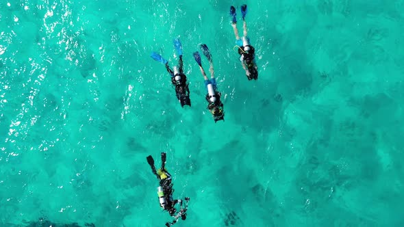 Scuba divers in clear water, Maldives, Kuredu