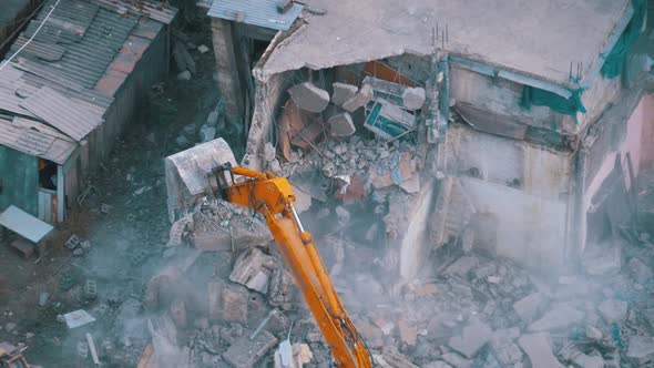 Destroying Old House Using Bucket Excavator on Construction Site.