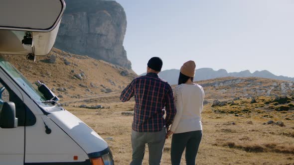 Couple Drink Coffee By Motorhome Rv and Enjoy Picturesque Landscape of Mountain in Autumn