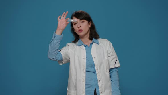 Chemical Scientist Analyzing Blood Sample on Glass Tray alt