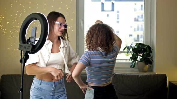 Cheerful Young Woman and Her Teenage Daughter are Actively Dancing Moving Emotionally Having Fun in