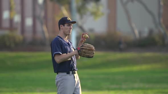 A young man playing catch with a baseball.