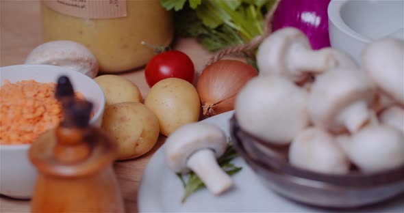 Fresh Food Ingredients On Wooden Table In Kitchen