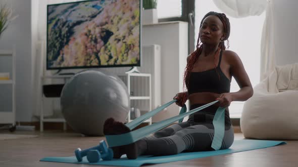 Athlete with Black Skin in Sportswear Exercising Body Muscle Using Fitness Elastic / Videohive