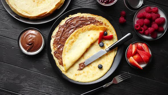 Delicious Chocolate Homemade Pancakes on Black Ceramic Plate