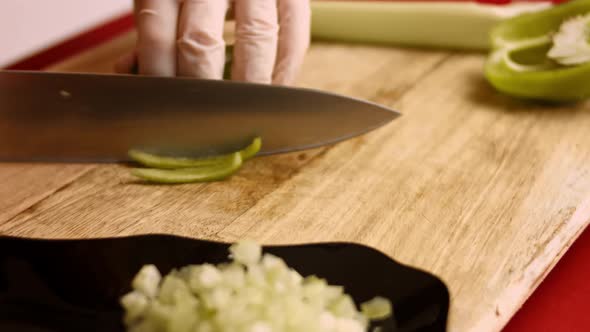 Close View Man's Hand Chopping Green Fresh Pepper with Sharp Knife