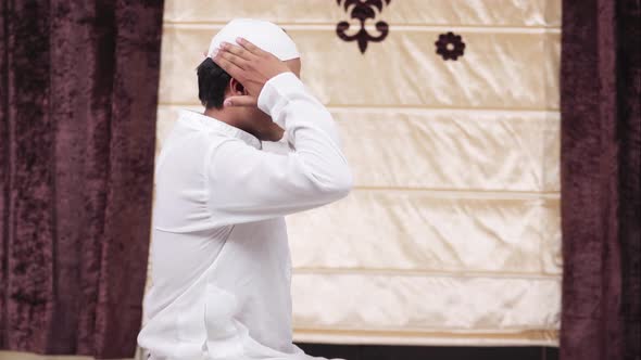 Muslim man adjusting cap