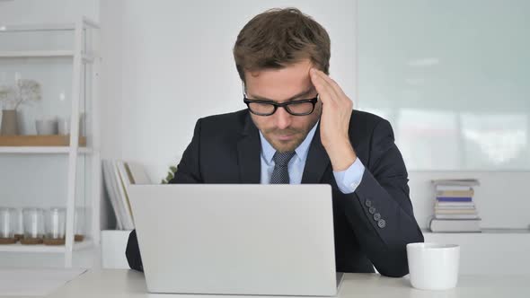 Headache Businessman in Stress at Work