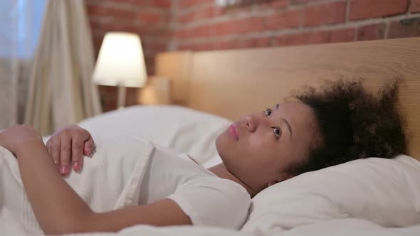 Young African Woman Sleeping in Bed Peacefully