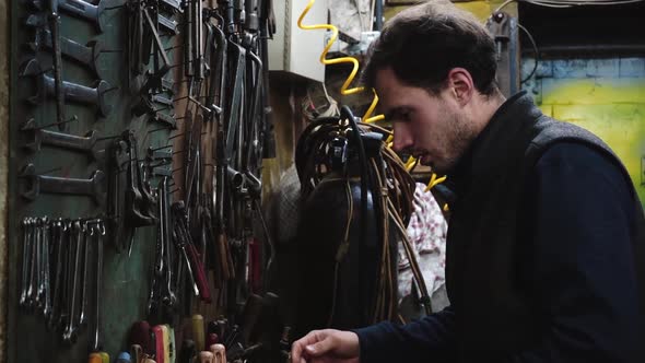 Man with Screwdriver at Workshop