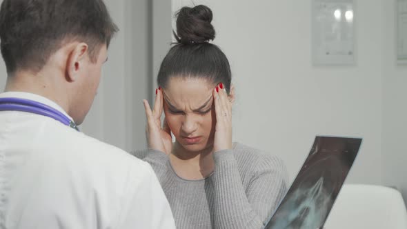 Young Woman with Terrible Migraine Visiting Doctor