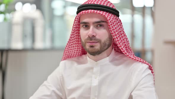 Serious Arab Businessman Looking at Camera in Office