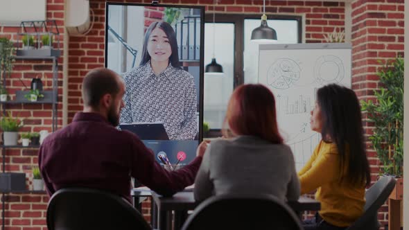 Group of Coworkers Using Video Call Communication in Boardroom