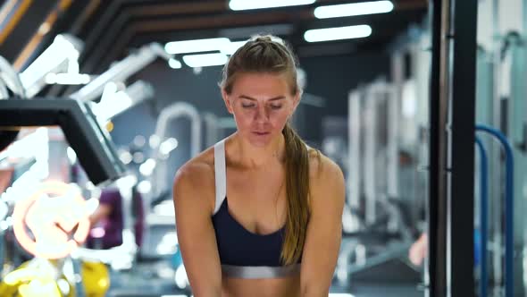 Fit Woman Working Out with Kettlebell in Gym