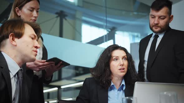 Female CEO Talking to Team at Business Meeting