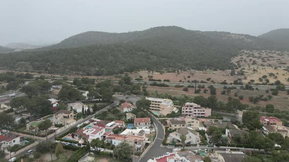 Hotel Buildings With Swimming Pools In The City In Mallorca Spain With Mountain Landscape In