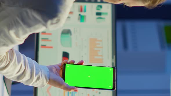 Vertical Video Back View of Business Woman Looking at Smartphone with Green Screen