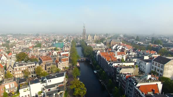The foggy Amsterdam canal in autumn