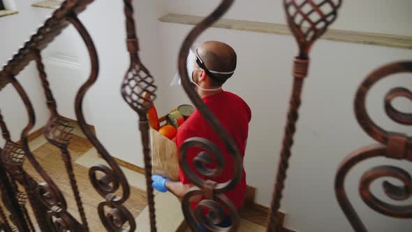 Food Courier with Groceries Wearing Mask