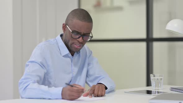 African Man Tearing Papers Unable to Write at Work