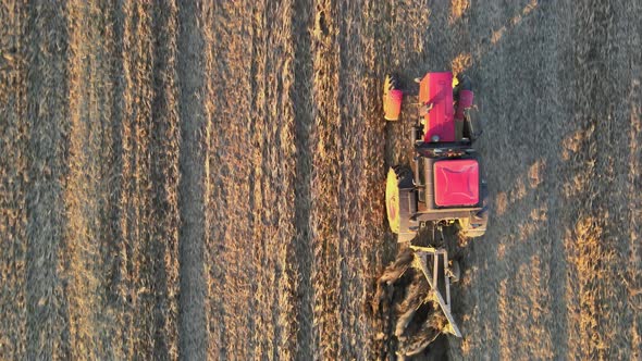 Farmer in Tractor at Work Preparing Plowing Land with Agricultural Field