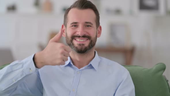 Young Man with Thumbs Up at Home