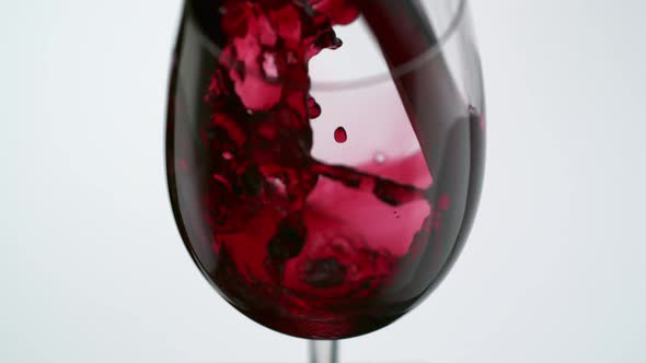 Pouring red wine into glass, Slow Motion