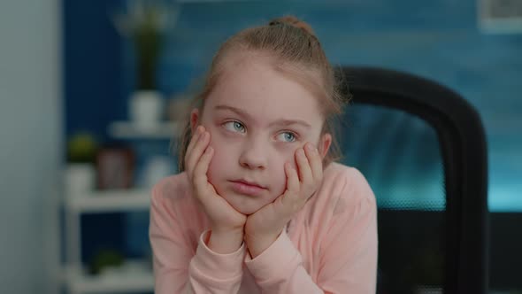 Close Up of Little Girl Feeling Exhausted and Looking at Computer