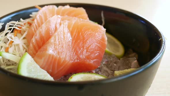 Portioned Raw Salmon Fillets in Ice with Lemon