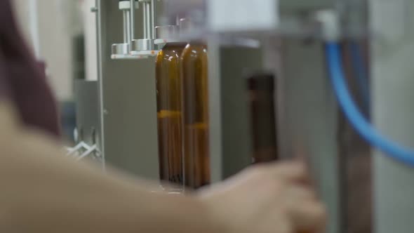 Wine Cork is Inserted Into the Bottle on a Machine