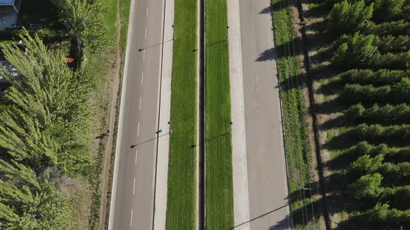 Aerial view over a road in the countryside surrounding areas of General Roca, Cordoba, Argentina