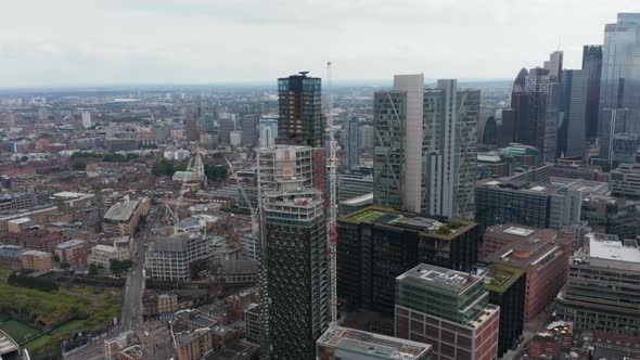 Slide and Pan Aerial Footage of Urban Neighbourhood and Business District