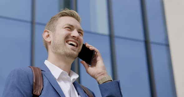 Businessman standing in the city talking on the phone