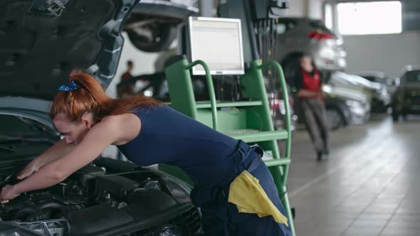 Woman Doing Car Check-up alt