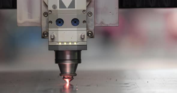 Automated Laser Cutter Cutting Metal Sheet With Sparks In A Factory