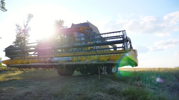 Front View of Grain Harvester Working on Farm at Sunny Day, Combine Riding To Gather Crop of Wheat