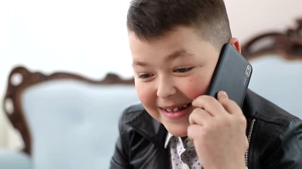 Little Schoolboy Talking on a Smartphone