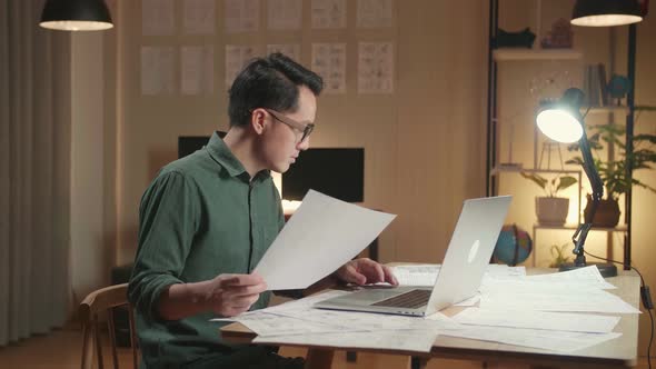 Creative Asian Designer Works On A Storyboard, Looks At His Sketches And Concepts