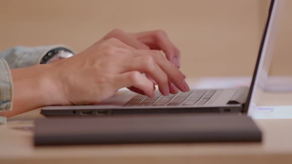 Close up of Asian male hands with short nails who is typing at the keyboard