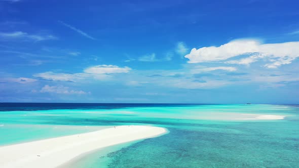 Daytime above abstract shot of a white paradise beach and blue water background