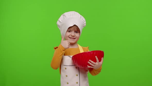 Child Girl Dressed Like Chef Baker Cook Mixing Dough in Bowl Preparing Bread Cake on Chroma Key