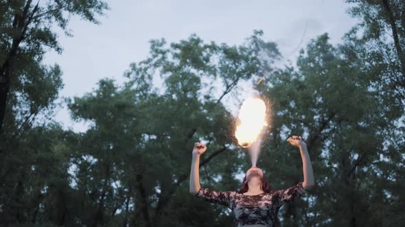 Portrait Cute Confident Woman Performing a Show with Flame Standing in the Forest or Park