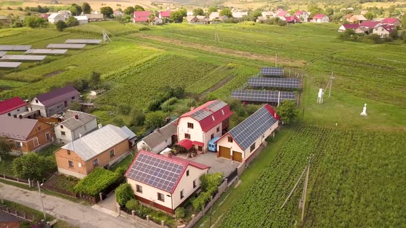 Aerial view of a row of  blue solar panels installed on the ground in residential area.