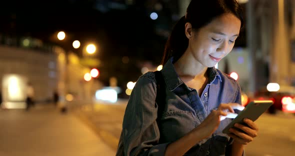 Woman using cellphone at night 