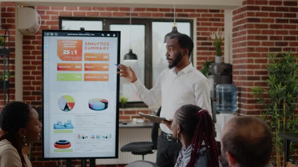 Business Man Using Monitor to Do Financial Presentation