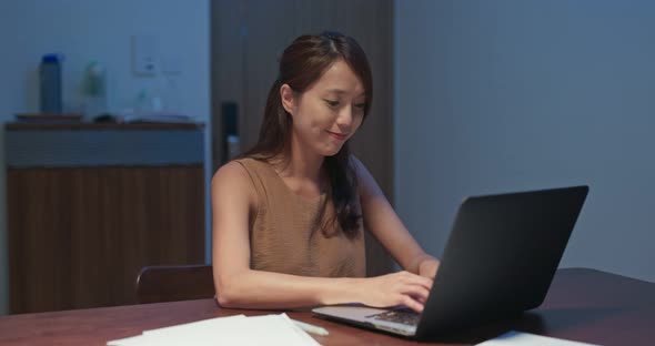 Woman feel annoy of using laptop computer at home in the evening