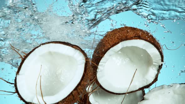 Super Slow Motion Shot of Flying Fresh Coconuts and Water Side Splash at 1000Fps.