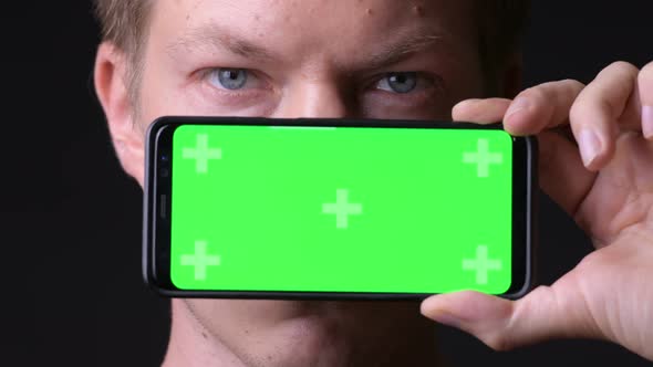 Young Handsome Man Using Mobile Phone with Green Screen Chroma Key